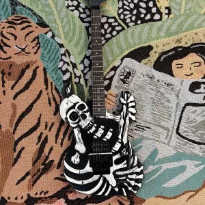 black 6 string electric guitar, double cranked vibrato system, skull carved body, personalized guitar, good sound quality