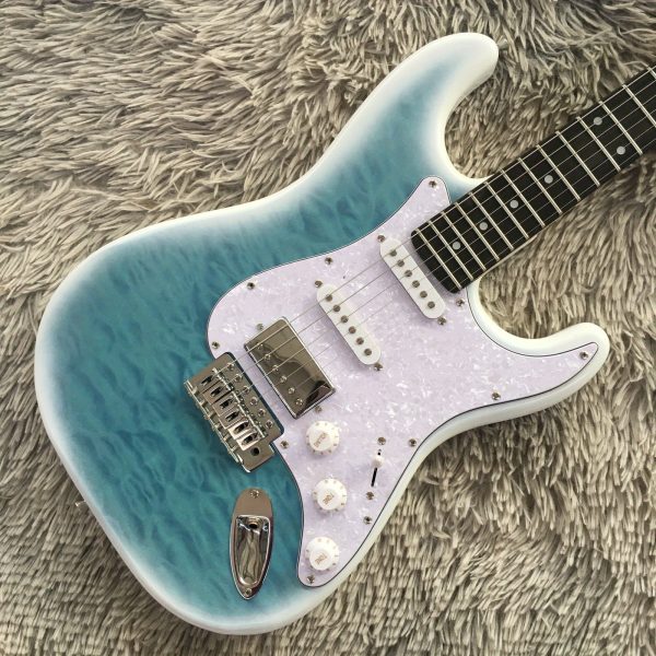 6 string st electric guitar light blue solid basswood body, maple neck, ssh pickups, rosewood fretboard, quilted maple top, chrome hardware, 22 frets, single tremolo bridge, fully enclosed design