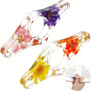 two handmade transparent thumb rings featuring dried flowers, designed as personalized bookmarks for book lovers and teachers, adding a stylish touch to reading.