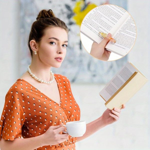 two handmade transparent thumb rings featuring dried flowers, designed as personalized bookmarks for book lovers and teachers, adding a stylish touch to reading.